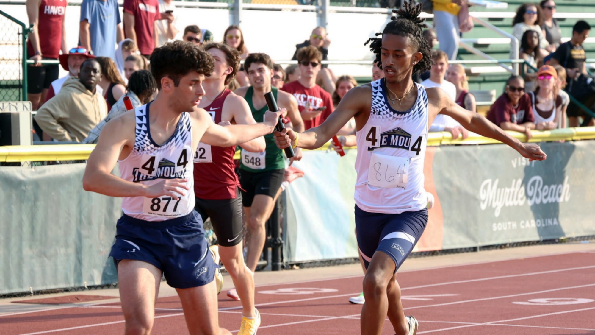 Relay Runners Engage in a Handoff at the Shamrock Invitational