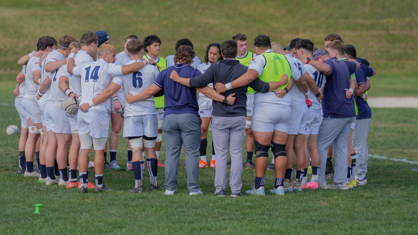 Men's Rugby in a Huddle Before the Game