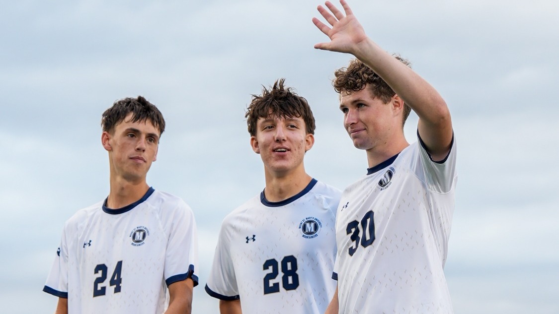Lincoln Bauer Waves to the Crowd as Dix and Alschner Look On
