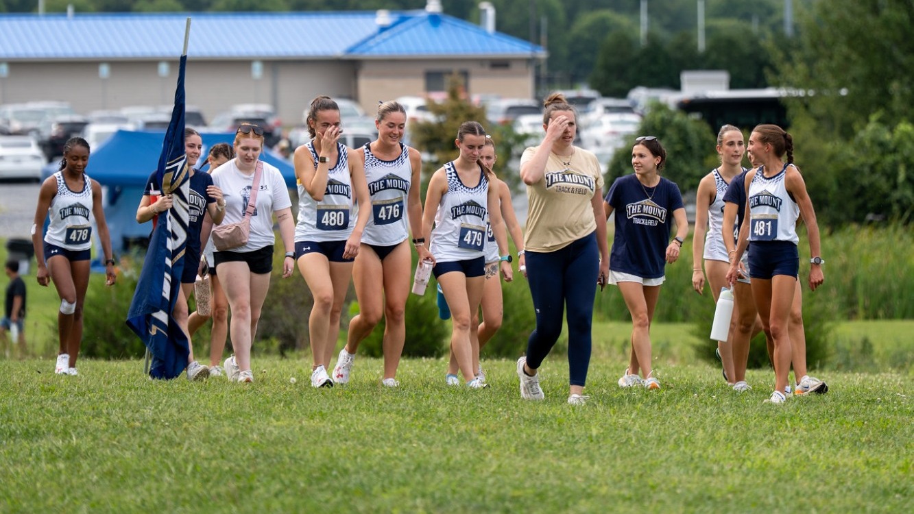 Head XC Coach Grace Baumgarten Leads the Team to the Start Line at the Mount 5K Duals