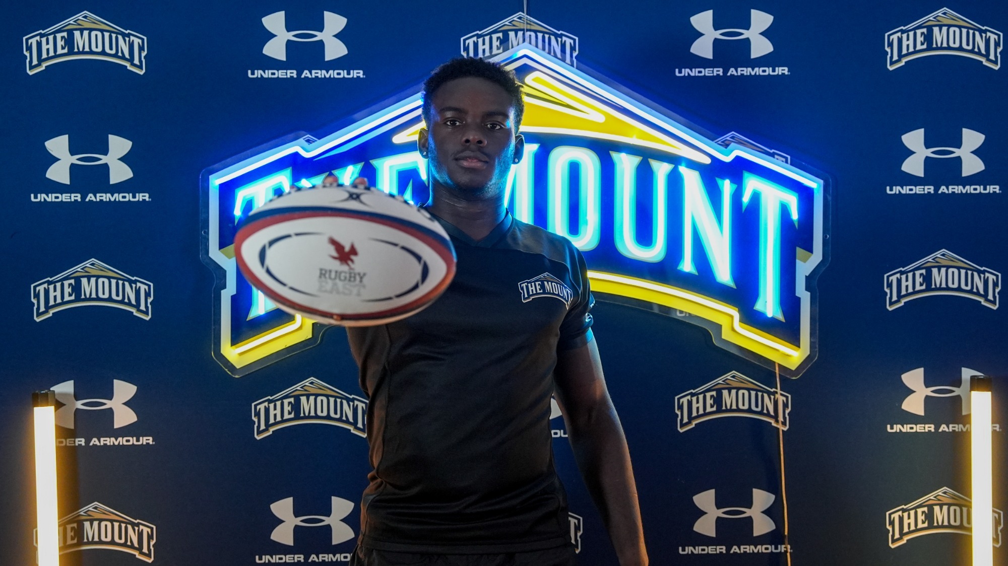 Raylon Murry Holding Out the Rugby Ball