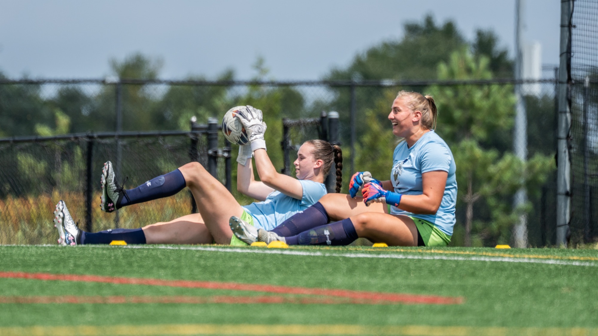 Goalies Anna Joyce and Anna Wall Share Smiles During Practice
