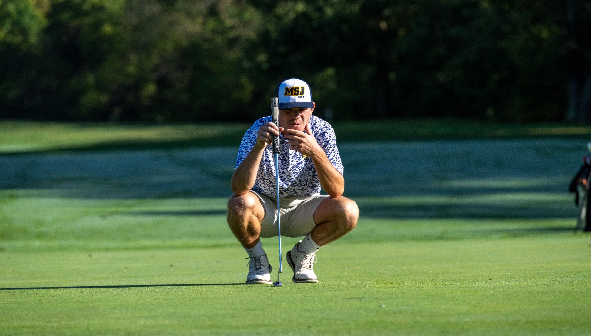 Men's Golfer eyeing a put