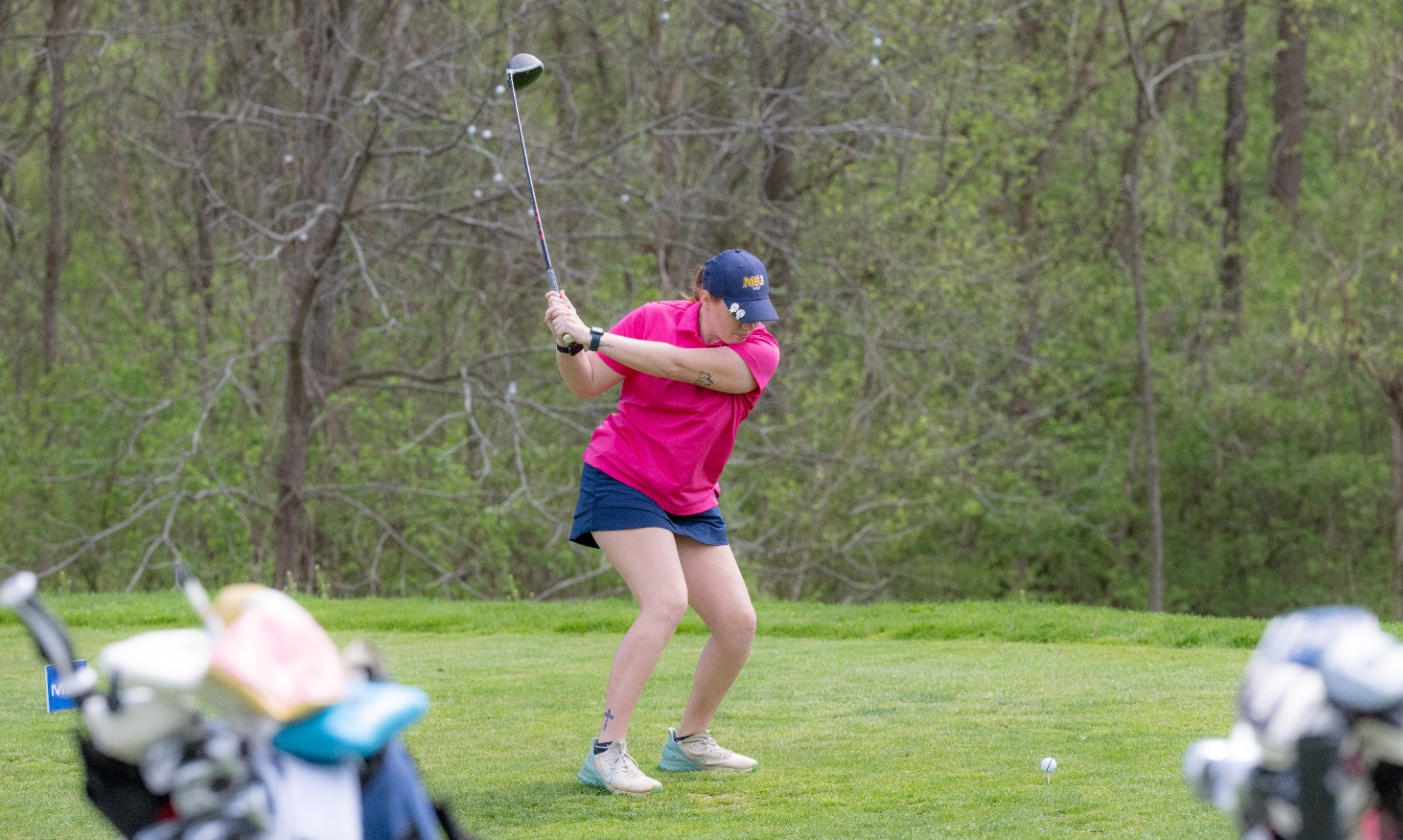 Women's Golfer teeing off