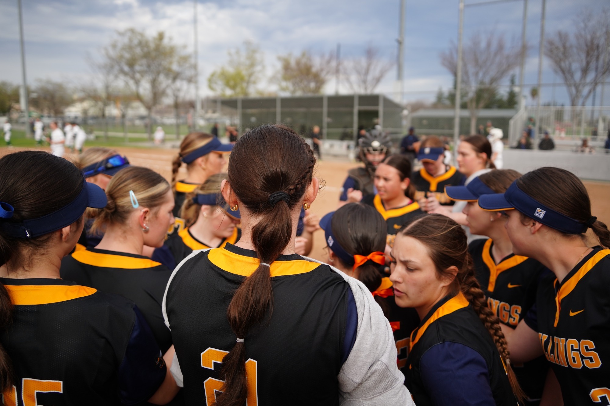 The Yellowjacket softball team huddles together before a game