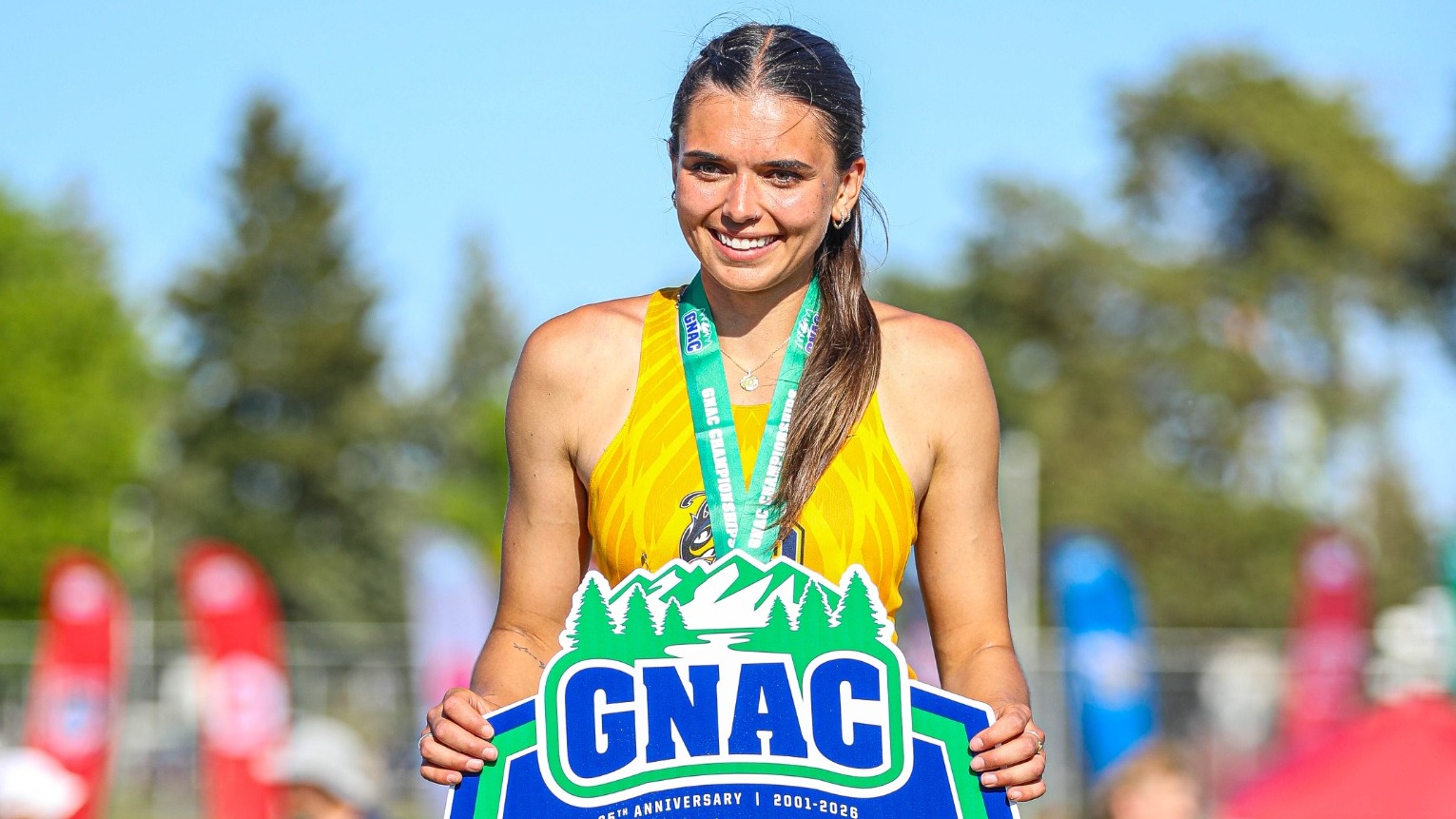 Hannah Cooper stands on the podium after winning gold for MSUB in the high jump at the GNAC Outdoor Championships