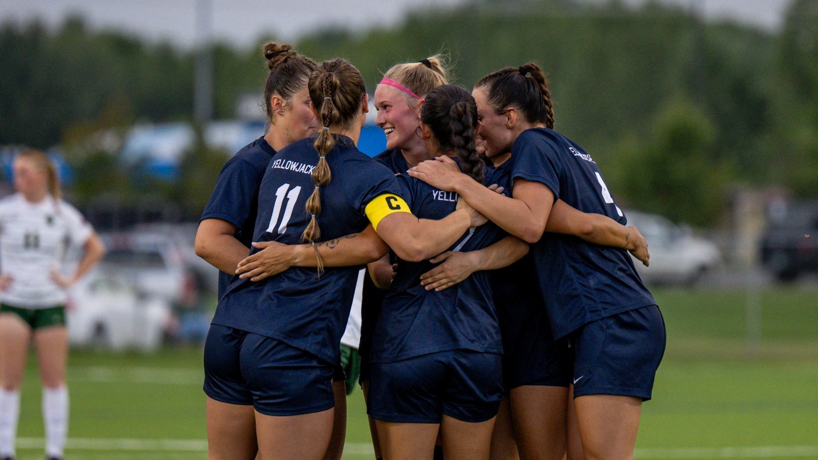 Members of the MSUB women's soccer team huddle to celebrate a goal scored by Cesia Swain