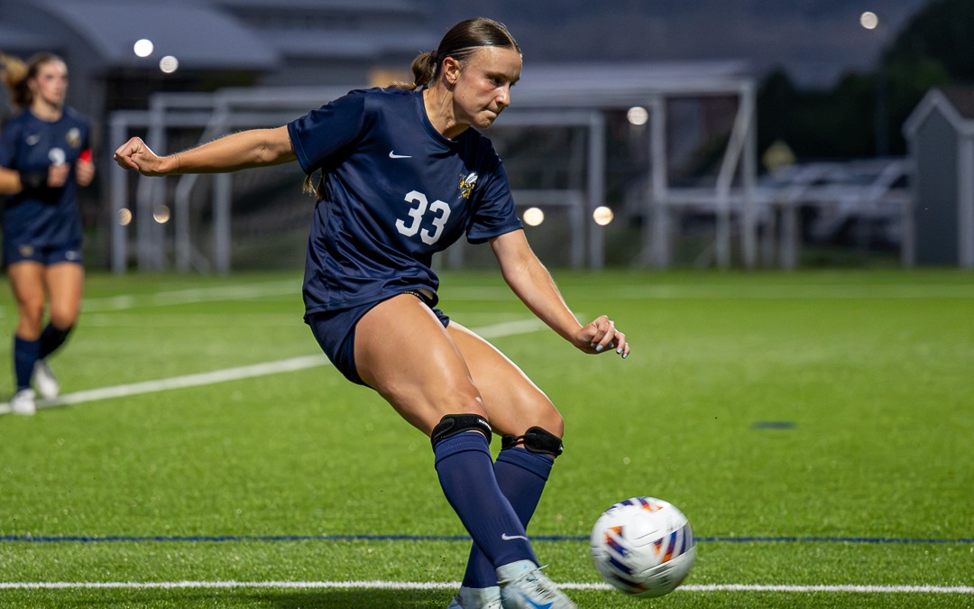 Ava Gibbs kicks the ball forward