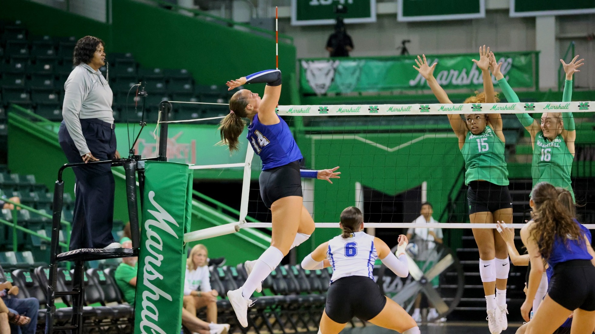 Blonde player in blue jersey swinging at a ball