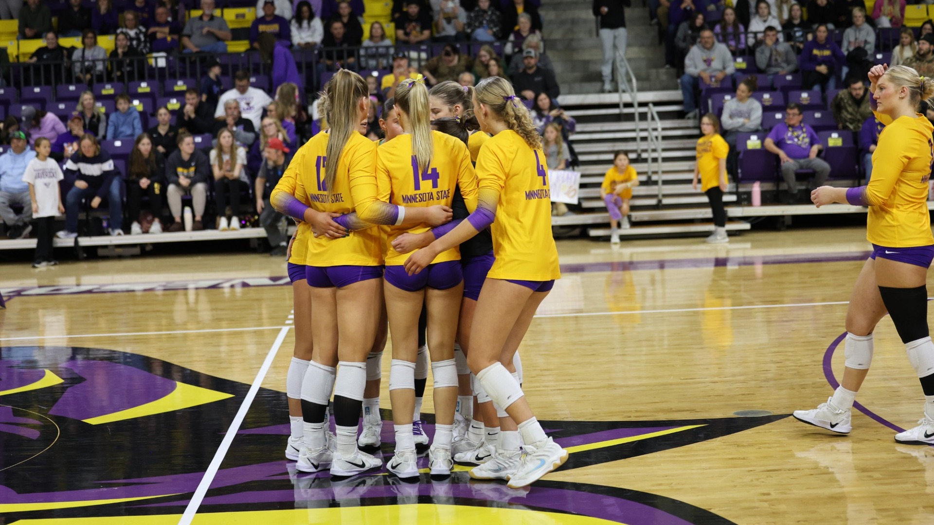 Volleyball team huddle during the NSIC Tournament