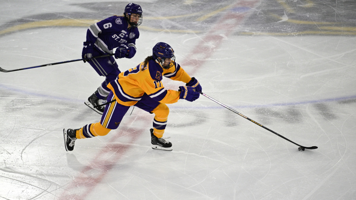 Lauren Zawoyski carries the puck over center icein MSU's 2-1 loss to St. Thomas (10.10)
