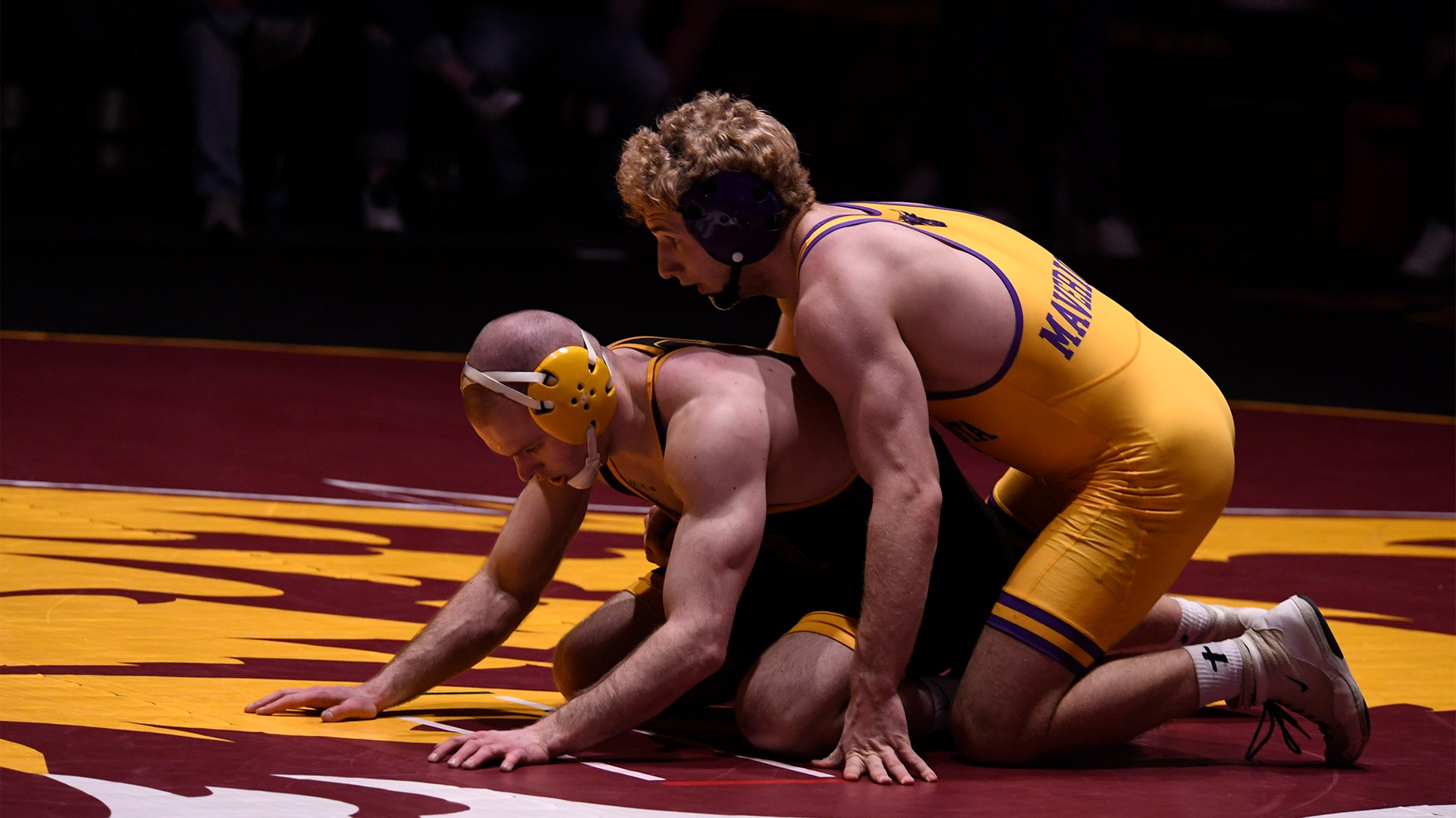 Marko works in the top position to control Northern State wrestler.