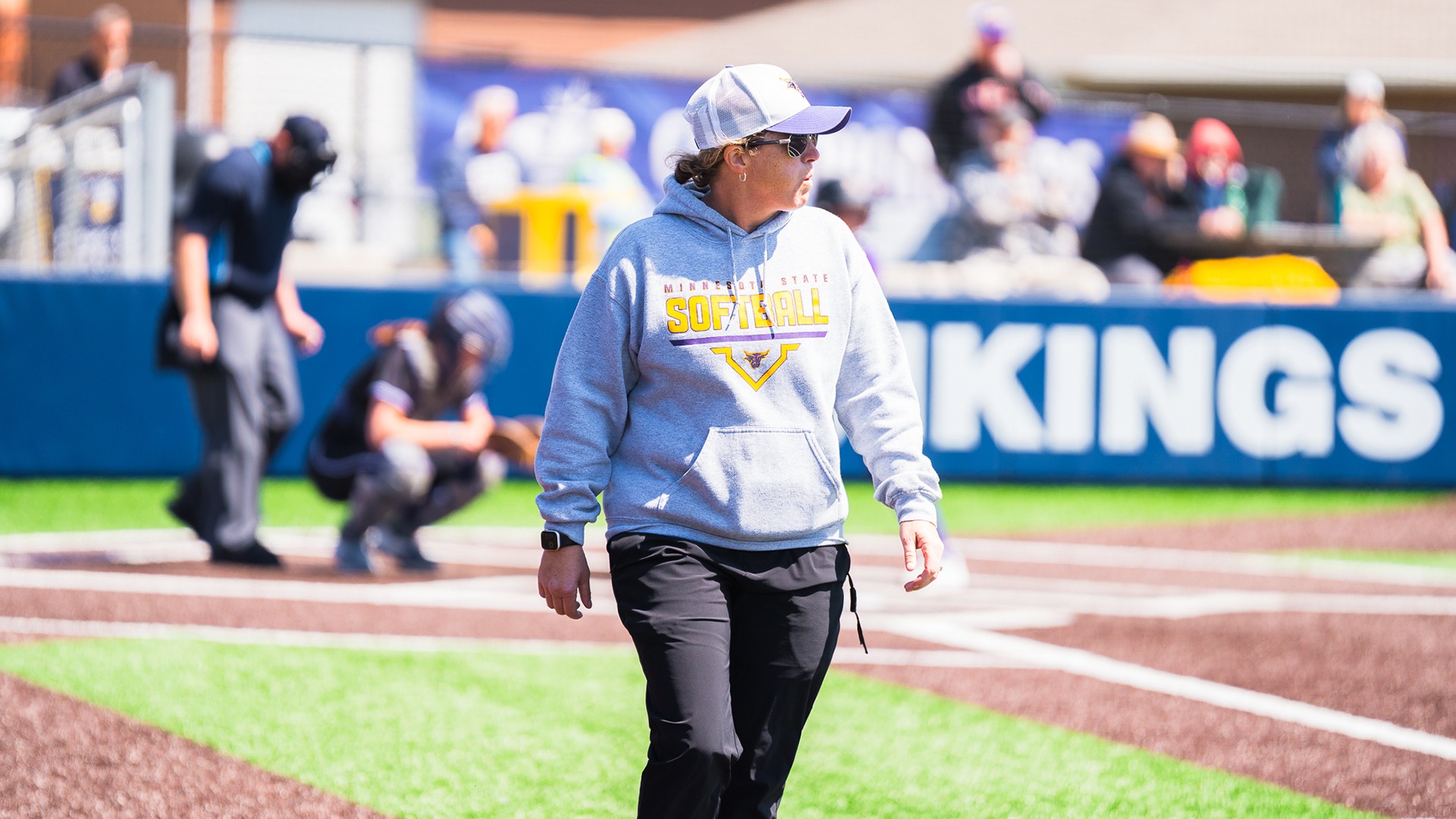 Kristle Wolcott walks to her position in the first base coaches box during MSU's NSIC Tournament game against Wayne State (5.1)
