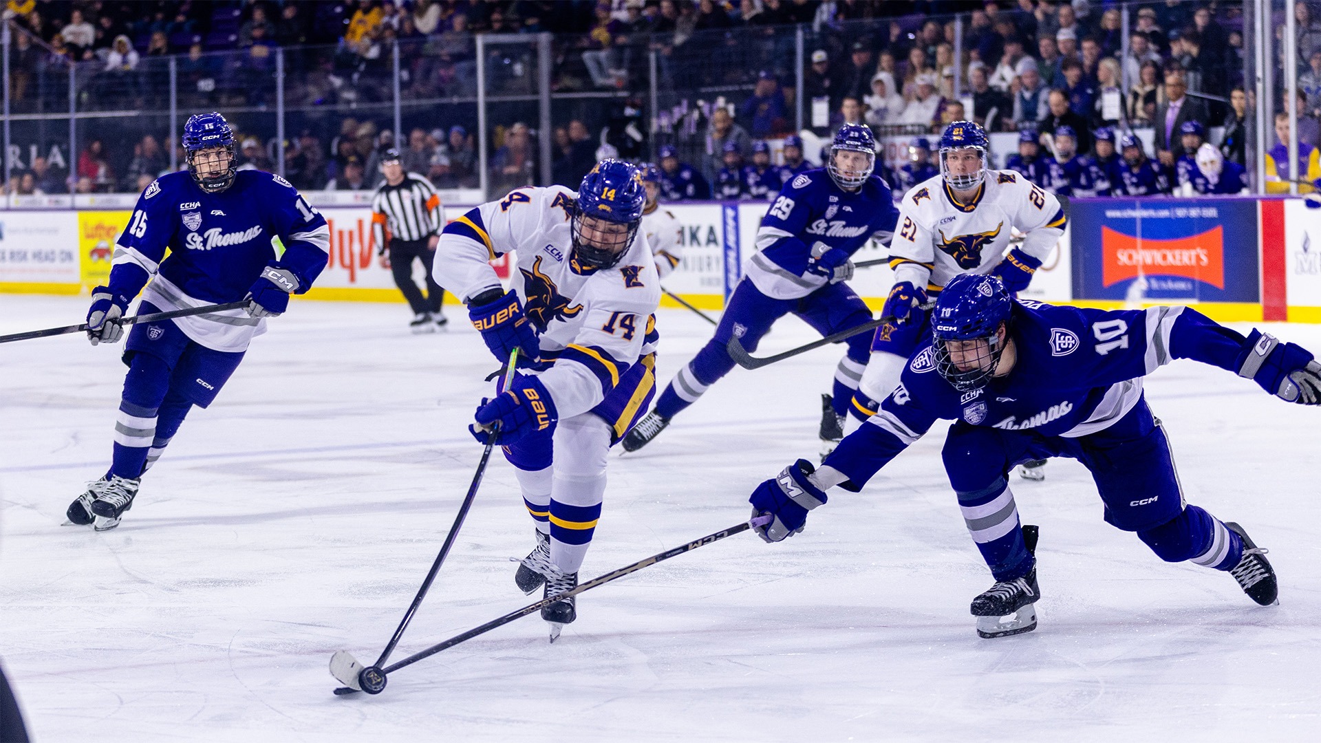 MAson LeBel reaches for the puck vs. St. Thomas at home.
