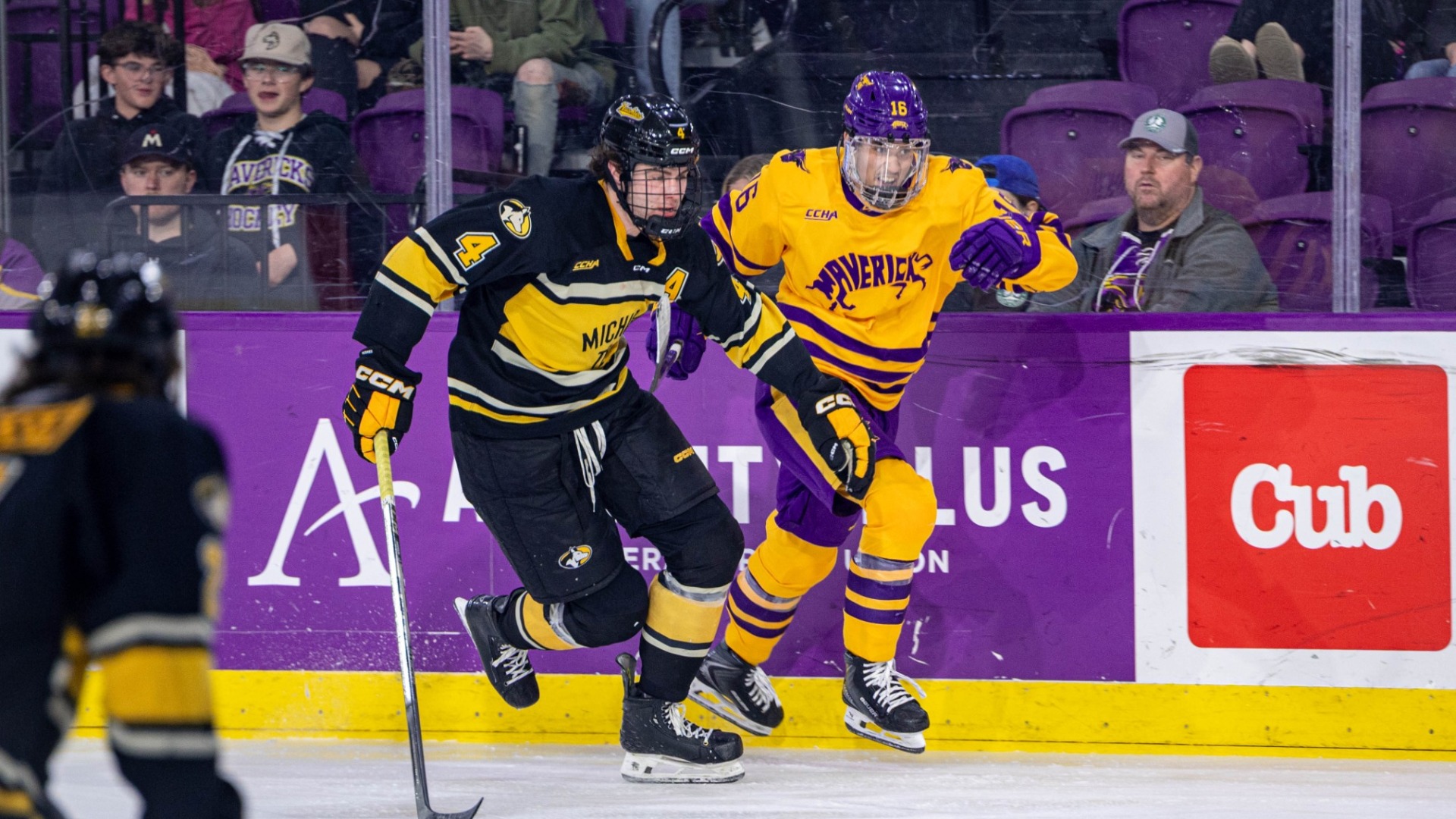 Jacob Bonkowski races along the boards for the puck vs. MTU
