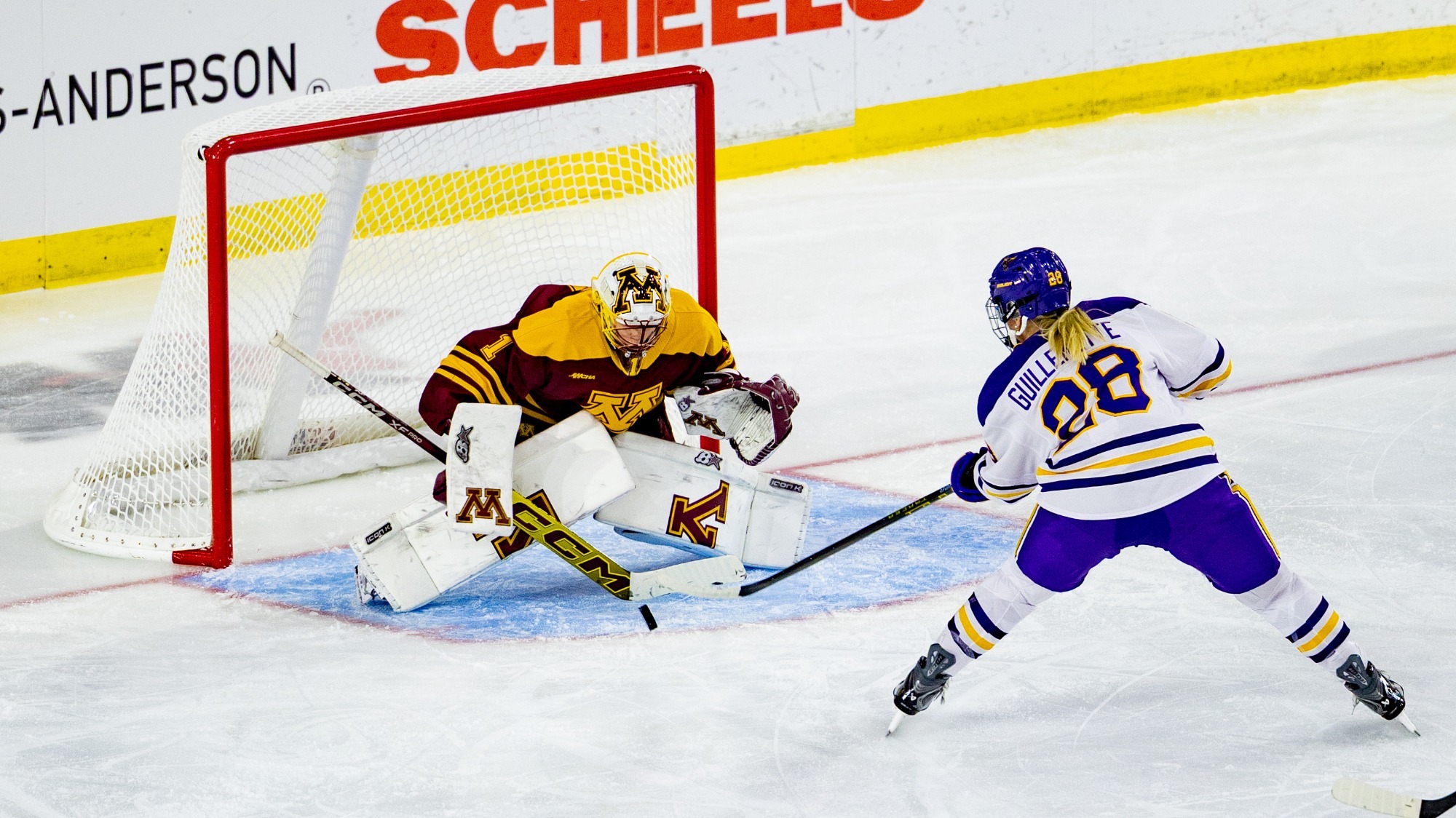 Ava Guillemette shooting the puck on Gopher goalie 