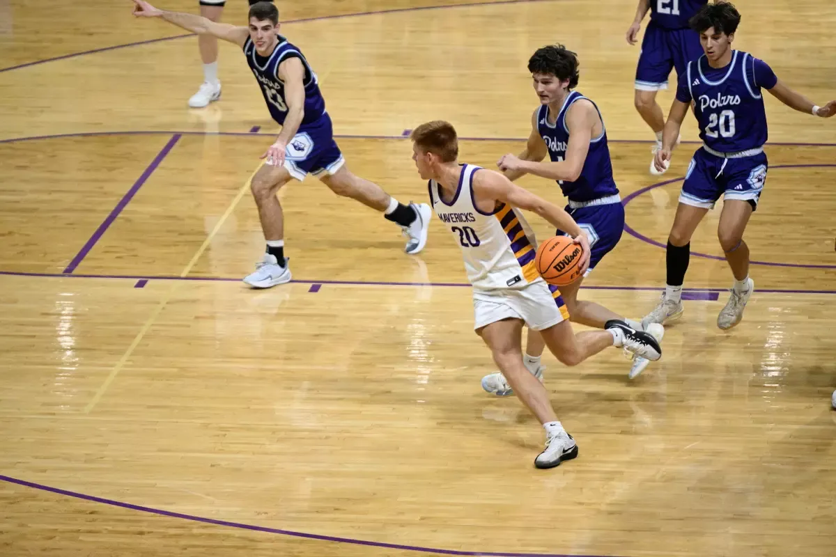 Chase Bartlett with the basketball vs. Crown College