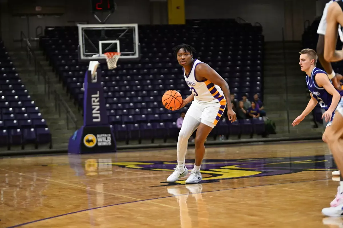 Phoenix Childs with the basketball vs. Crown College
