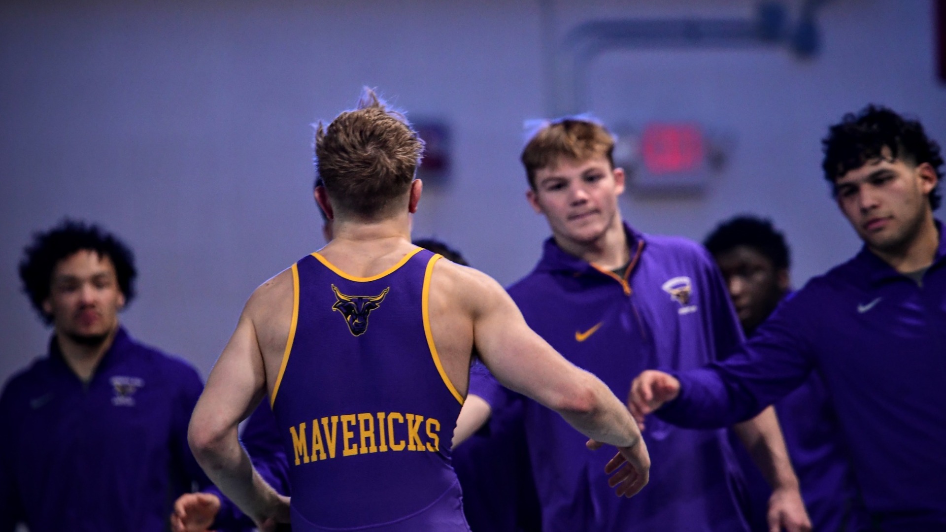 Chase Beckett greets teammates after a win at UIU