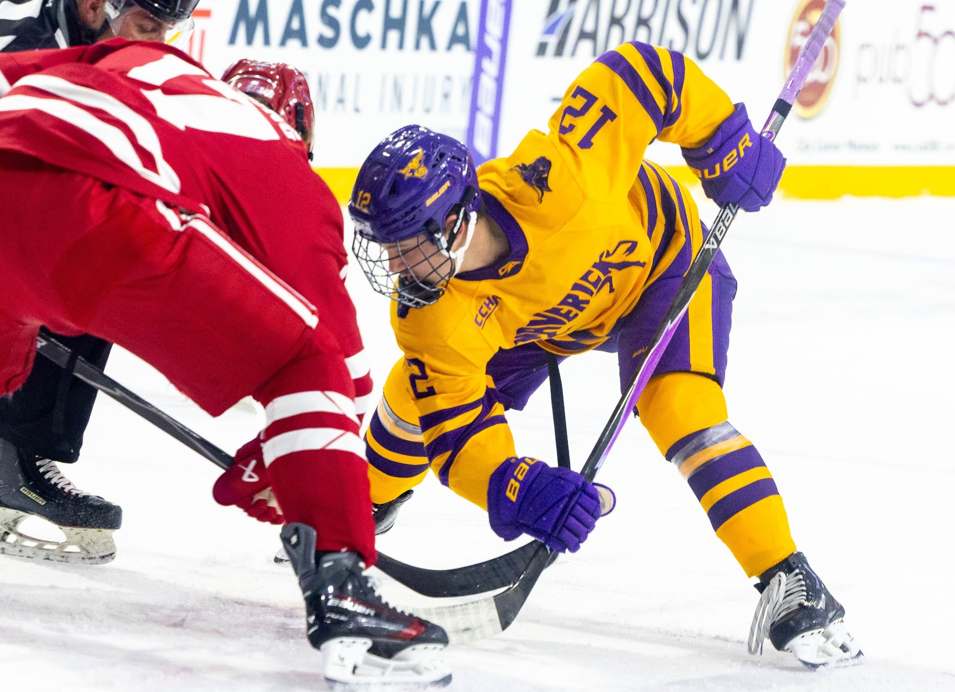 Alex Zetterberg taking the faceoff against Wisconsin