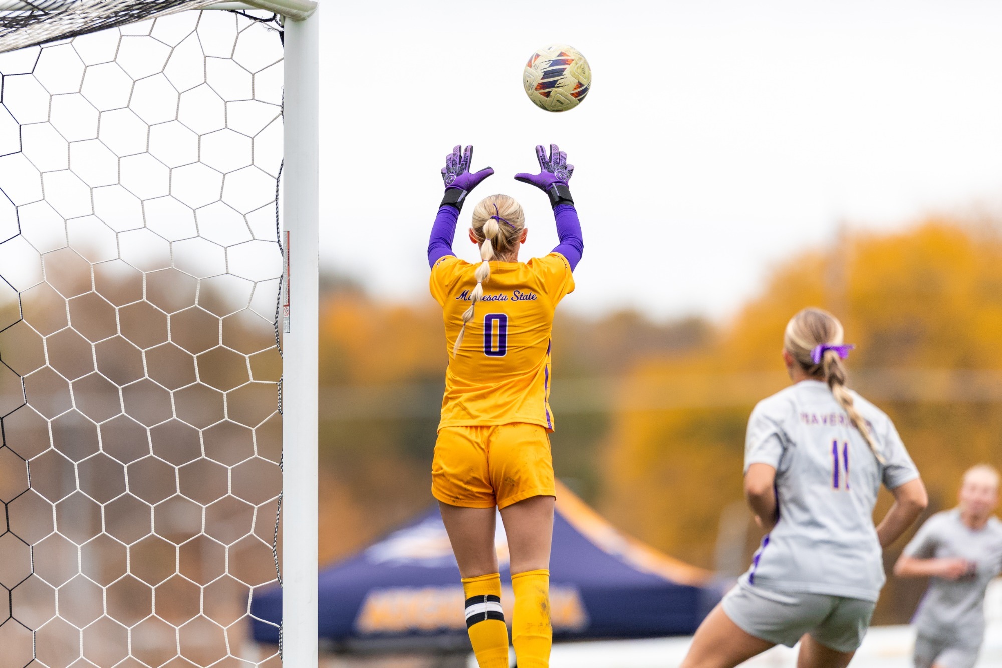 Lauren McAlpine skies for a save against Augustana