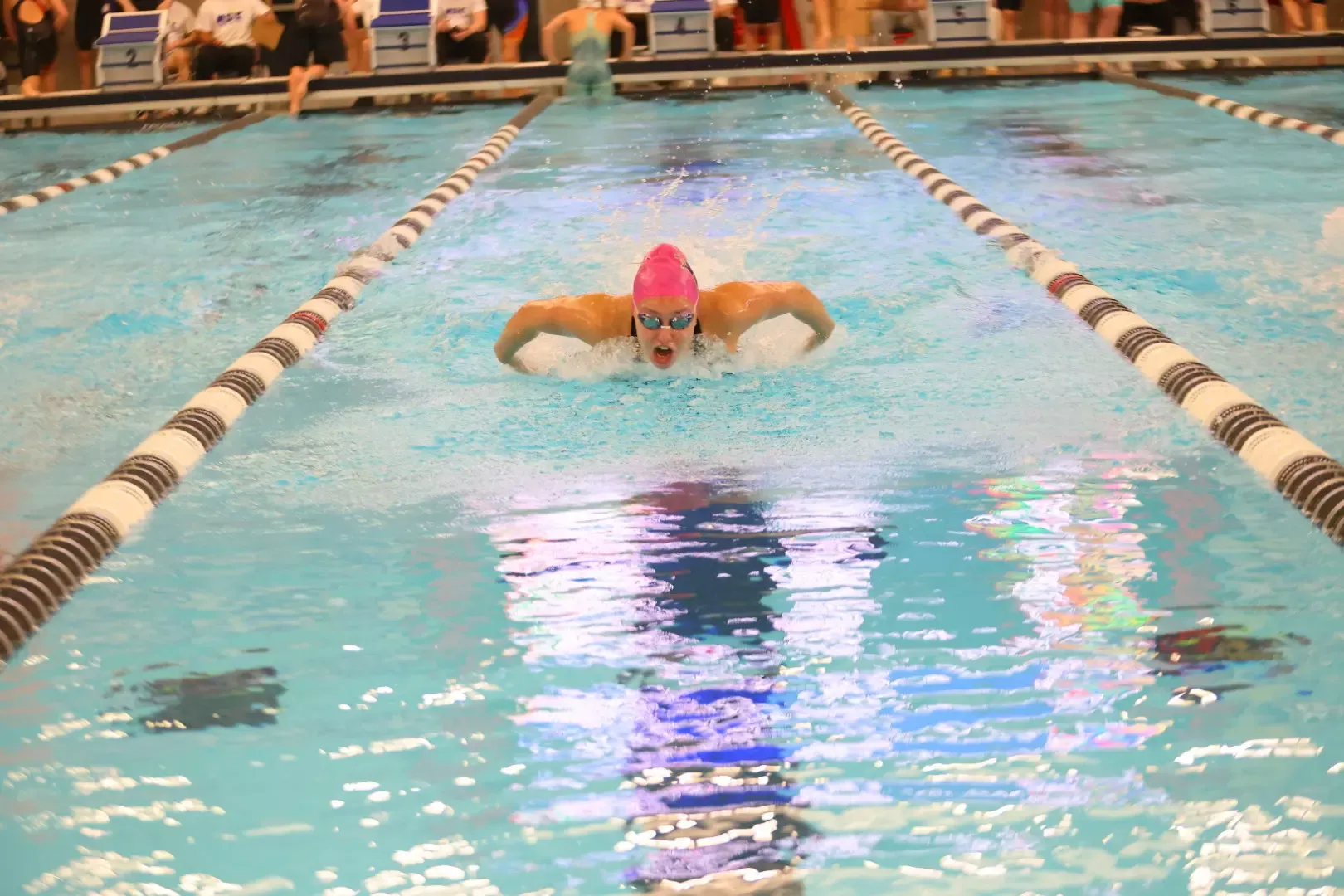 Savannah Acker swimming in the 200 IM prelims at the NSIC Championships