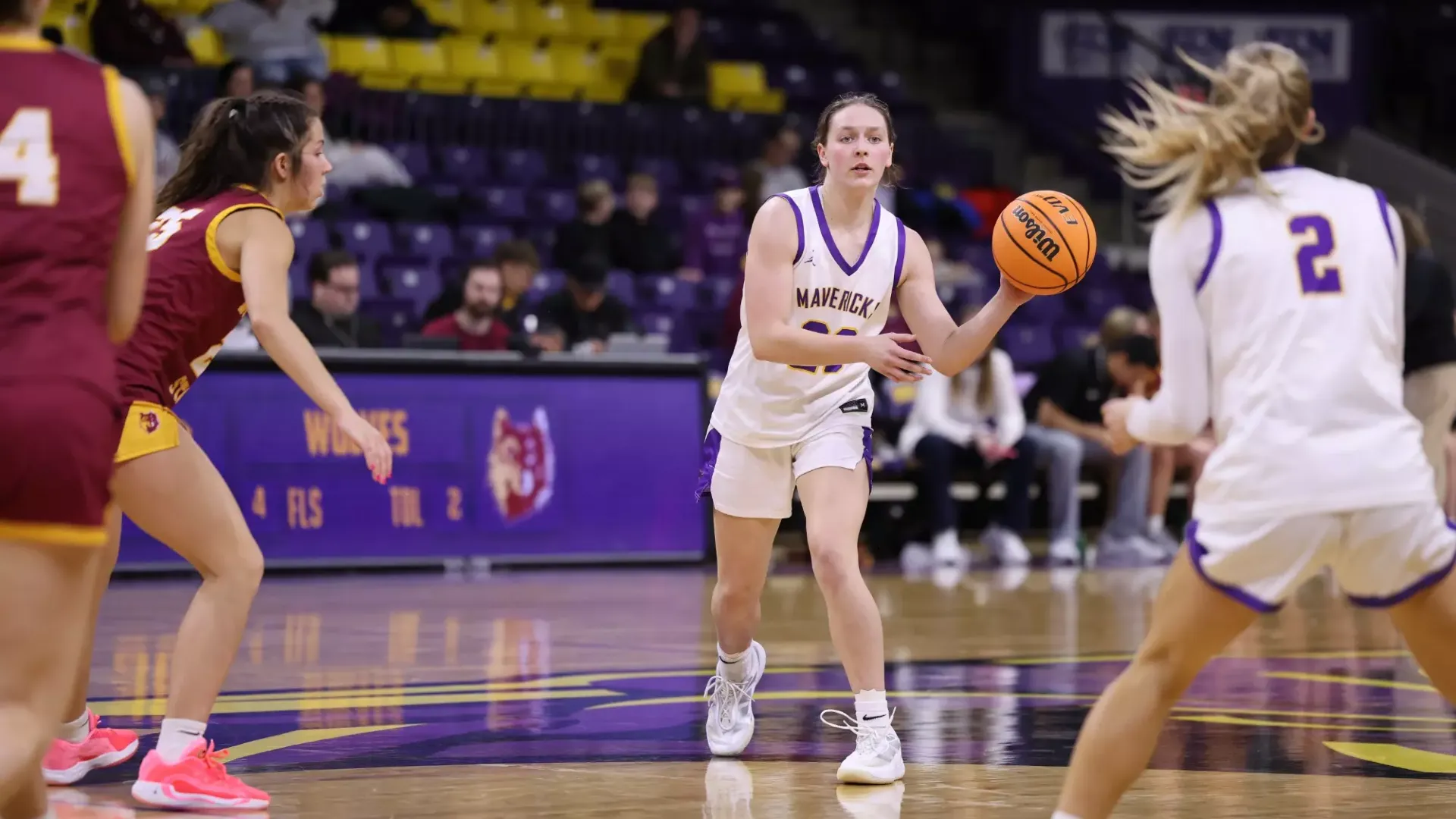 Haylee Stokes pass the ball inside the Taylor Center