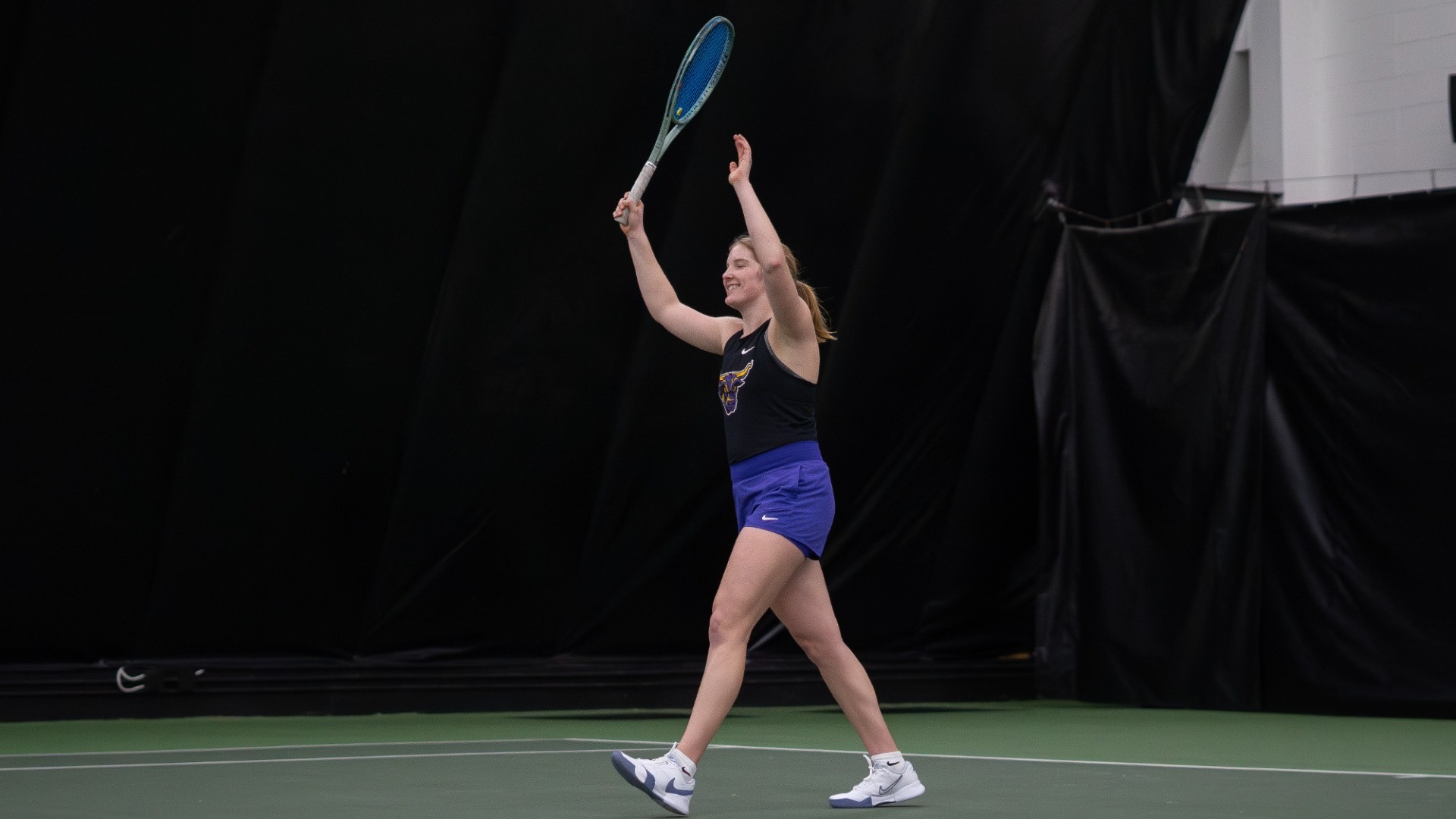Julia Gurholt celebrates a win for the tennis team