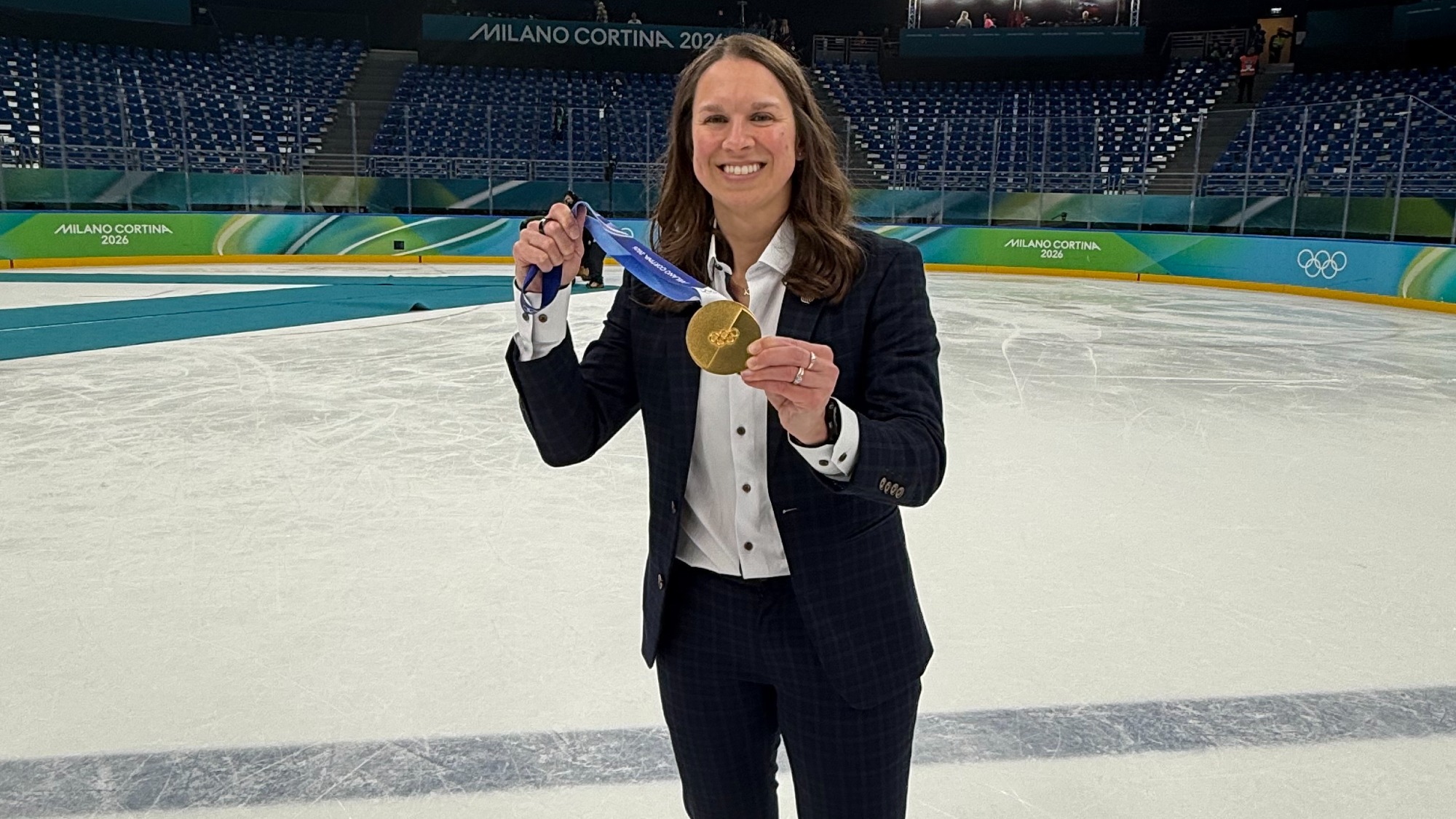 A photo of Shari Dickerman with the Olympic Gold Medal following MSU's 2-1 win over Canada in the 2026 Olympic Championship game