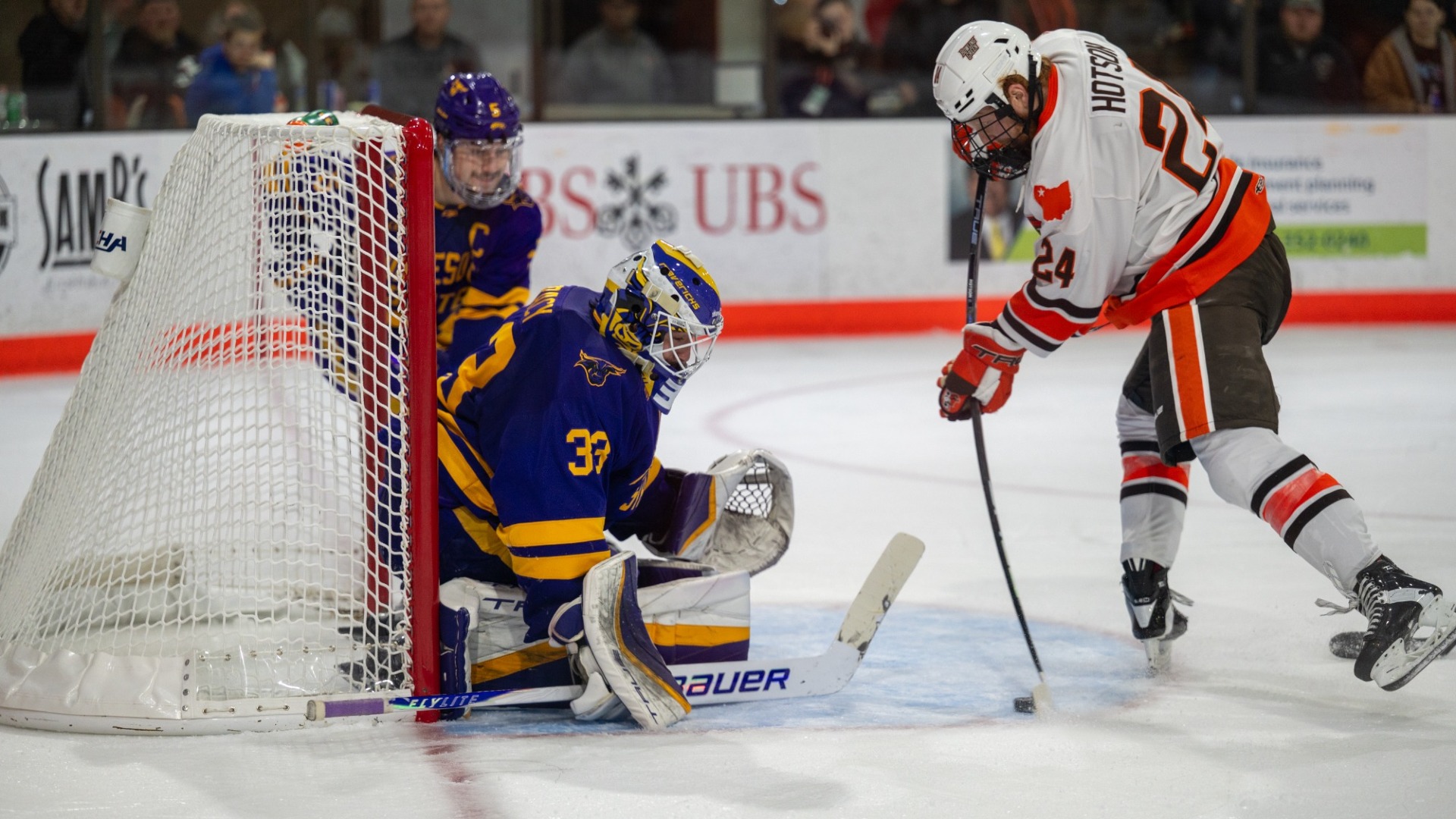 Alex Tracy stopped the puck against Tyler Hotson of Bowling Green Friday