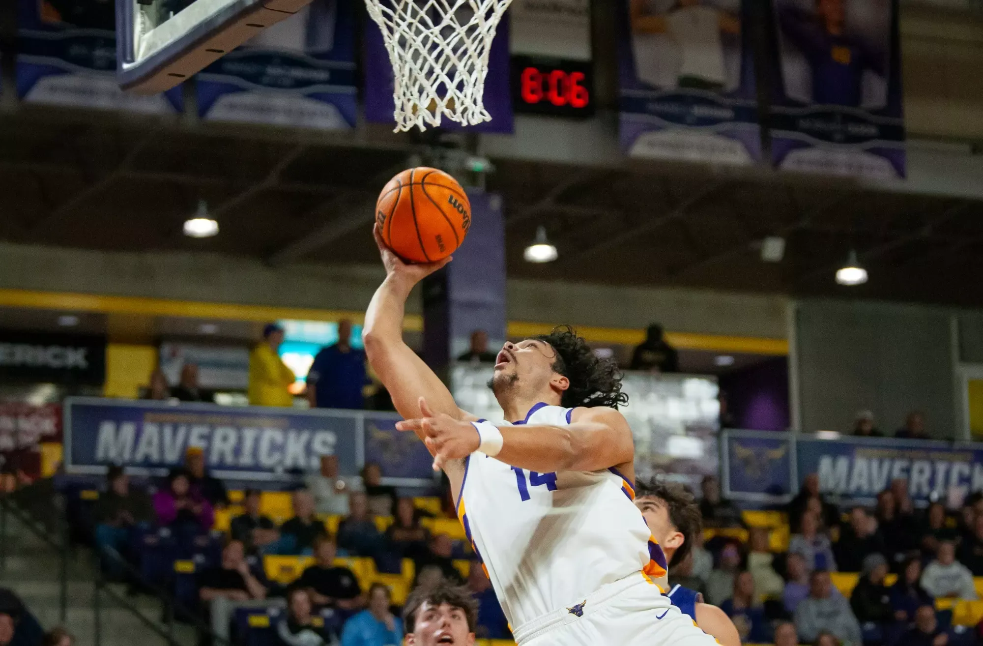 Malcolm Jones driving to the basket against Winona State