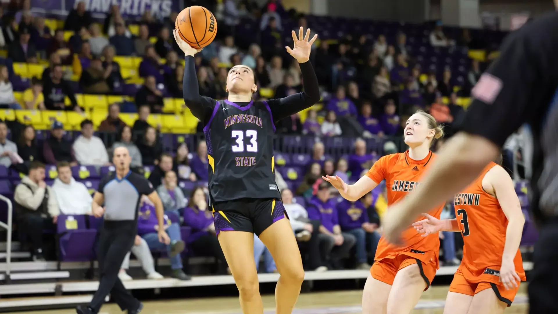 Ava Stier goes up for a layup against the Jimmies
