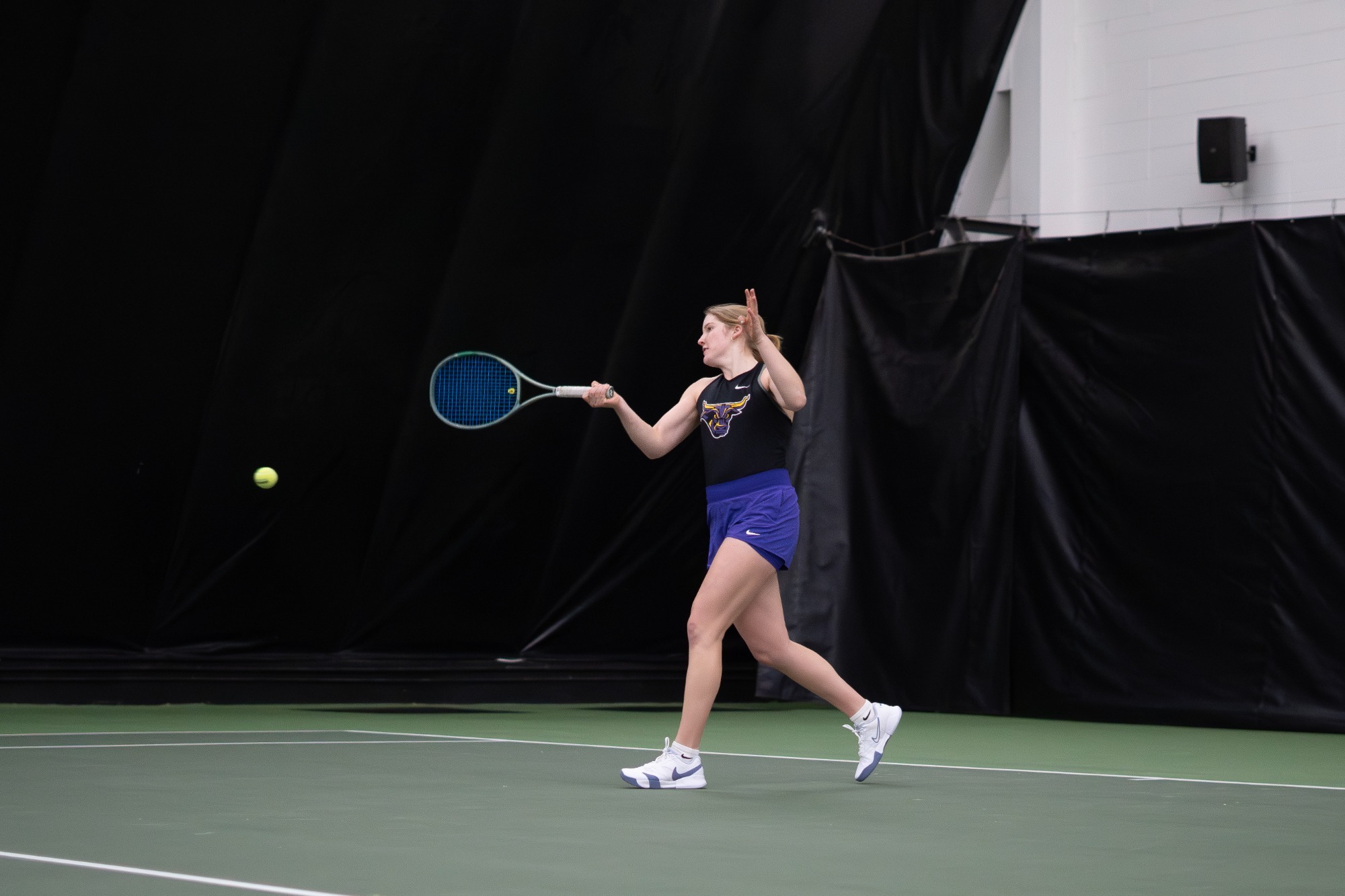 Julia Gurholt swinging at the tennis ball