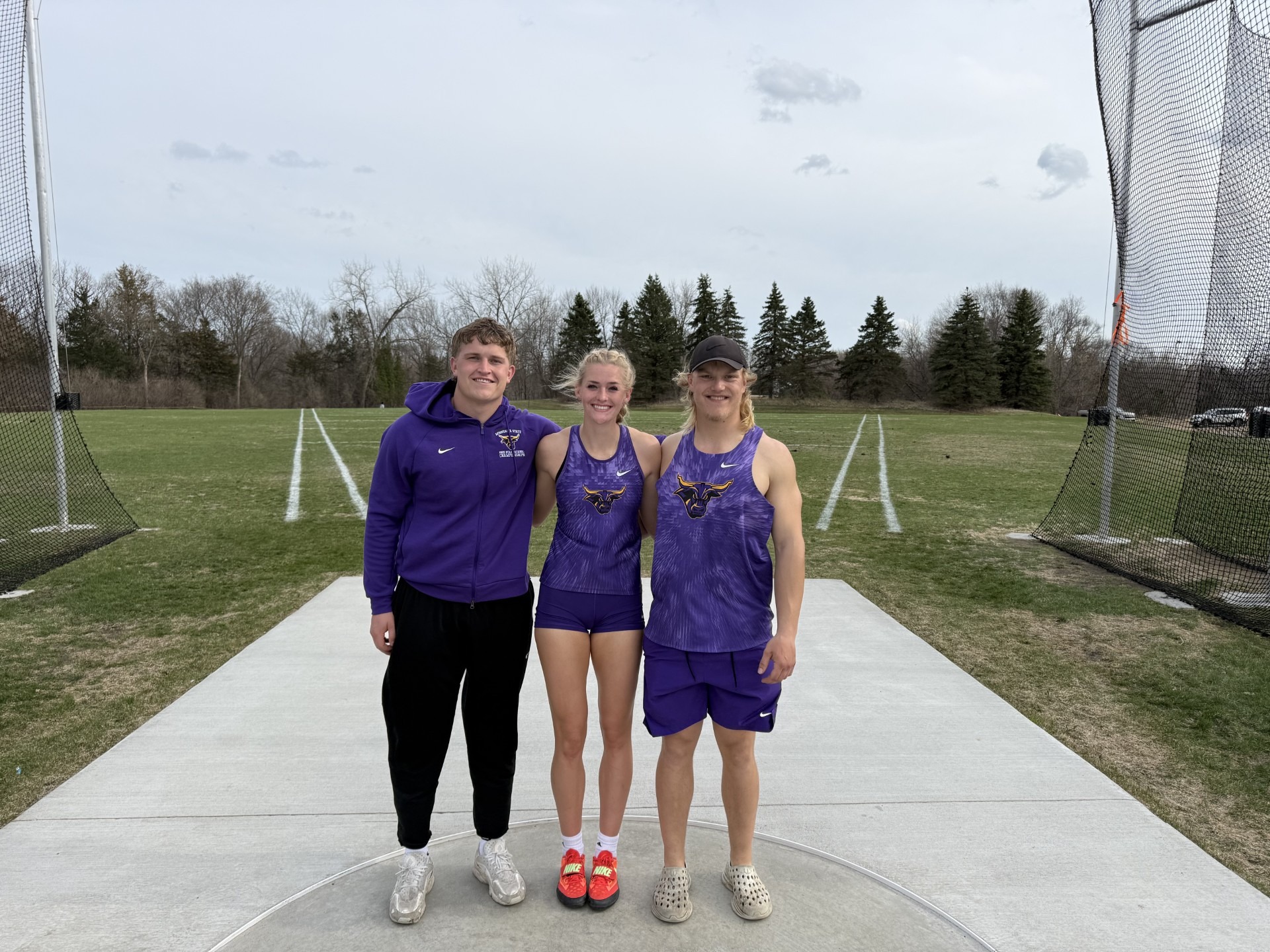 Hayden Bills, Dylan Gross and Elise Jensen after setting school records in the discus event at the Minnesota State Open