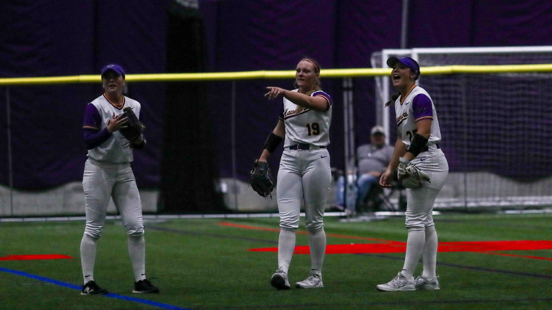 Softball Outfielders talking before the play starts