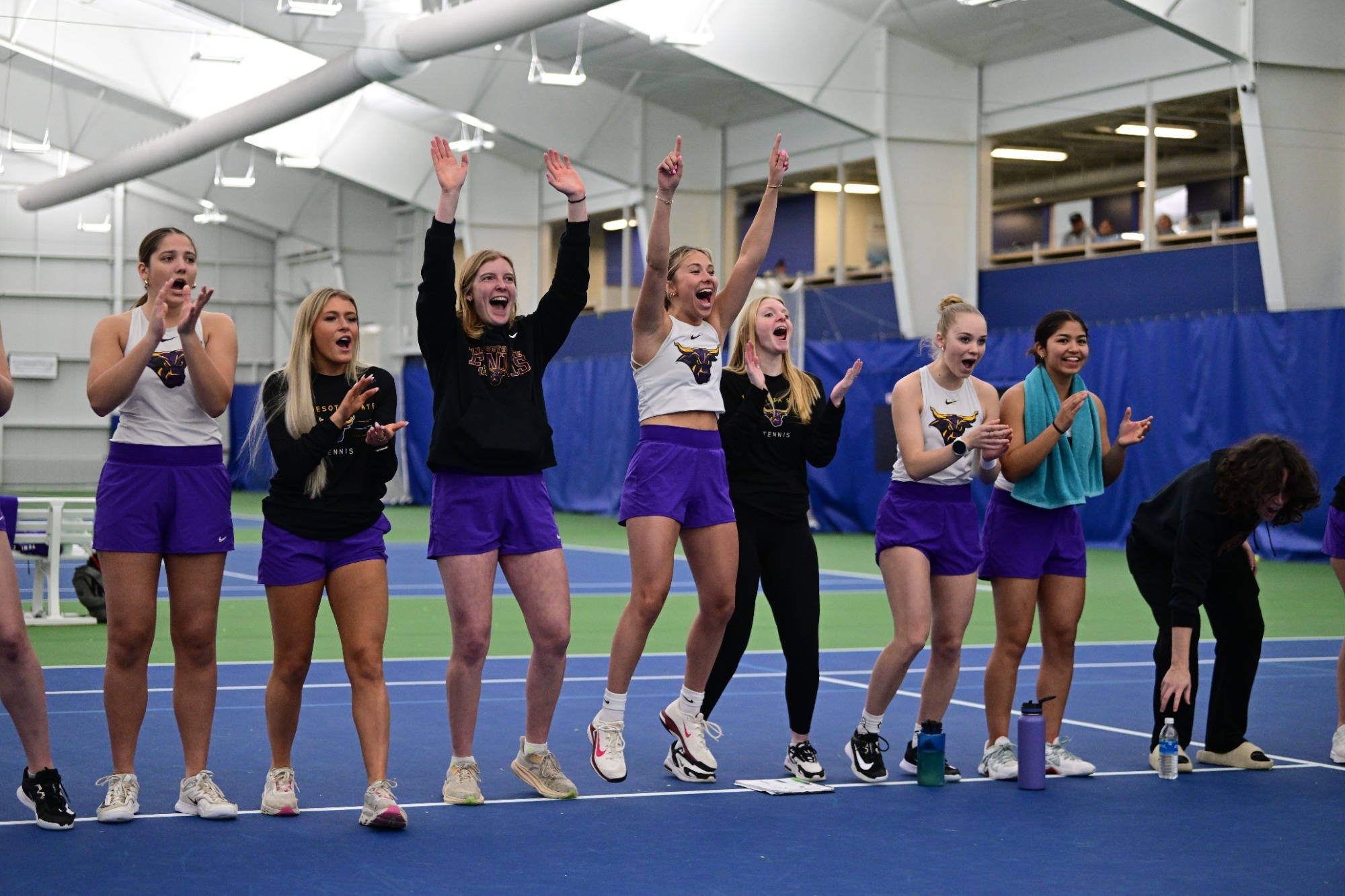Tennis Team celebrating during dual vs. Sioux Falls in the NSIC Tournament
