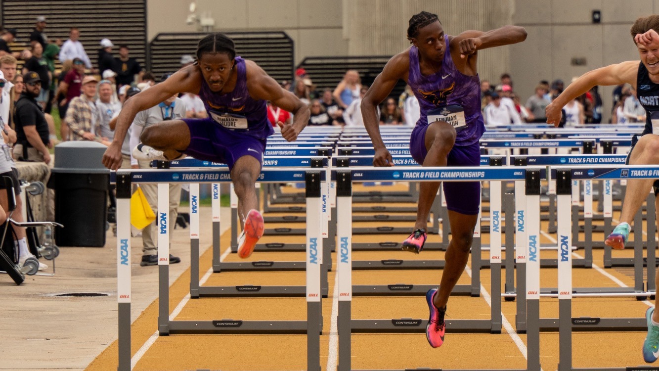 Rinaldo Moore and Kenjuan Hampton competing in the 110m hurdles event at the NCAA Championships
