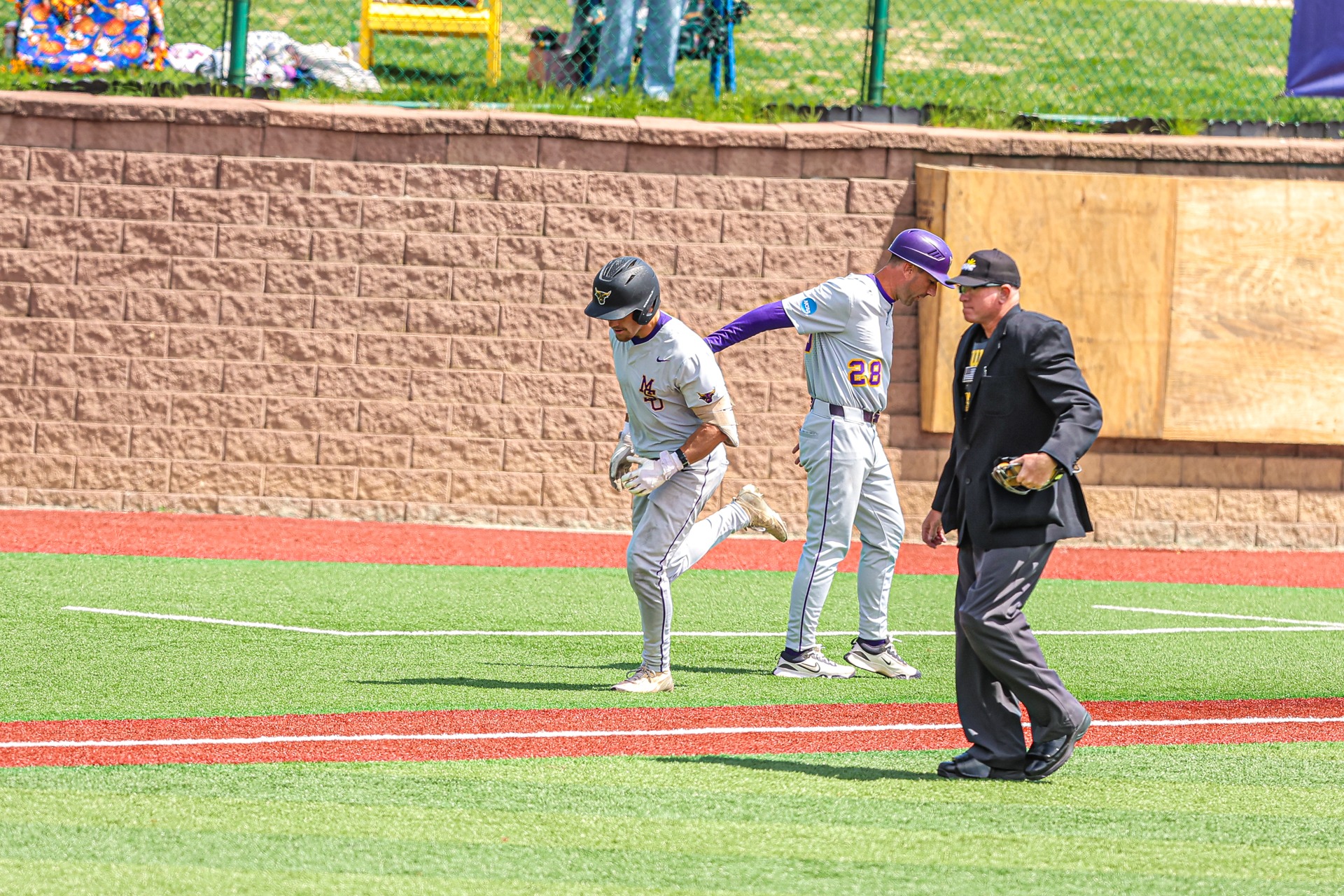 Ethsn Bowers rounding third base after hitting a home run against Augustana