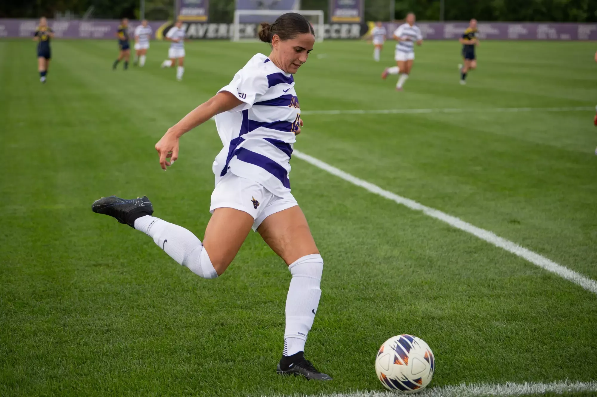 Mila Rustin kicking the ball 