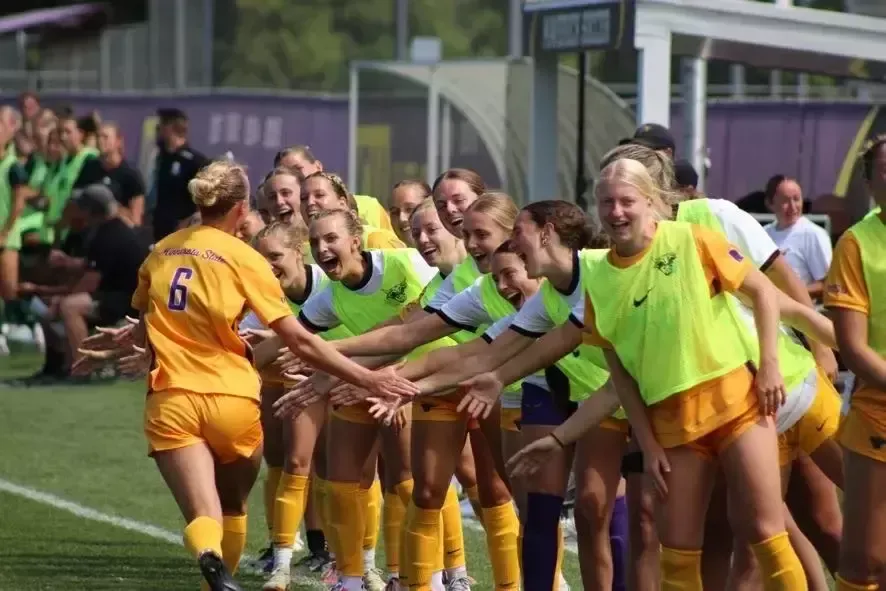 Archer celebrates with sideline after a goal