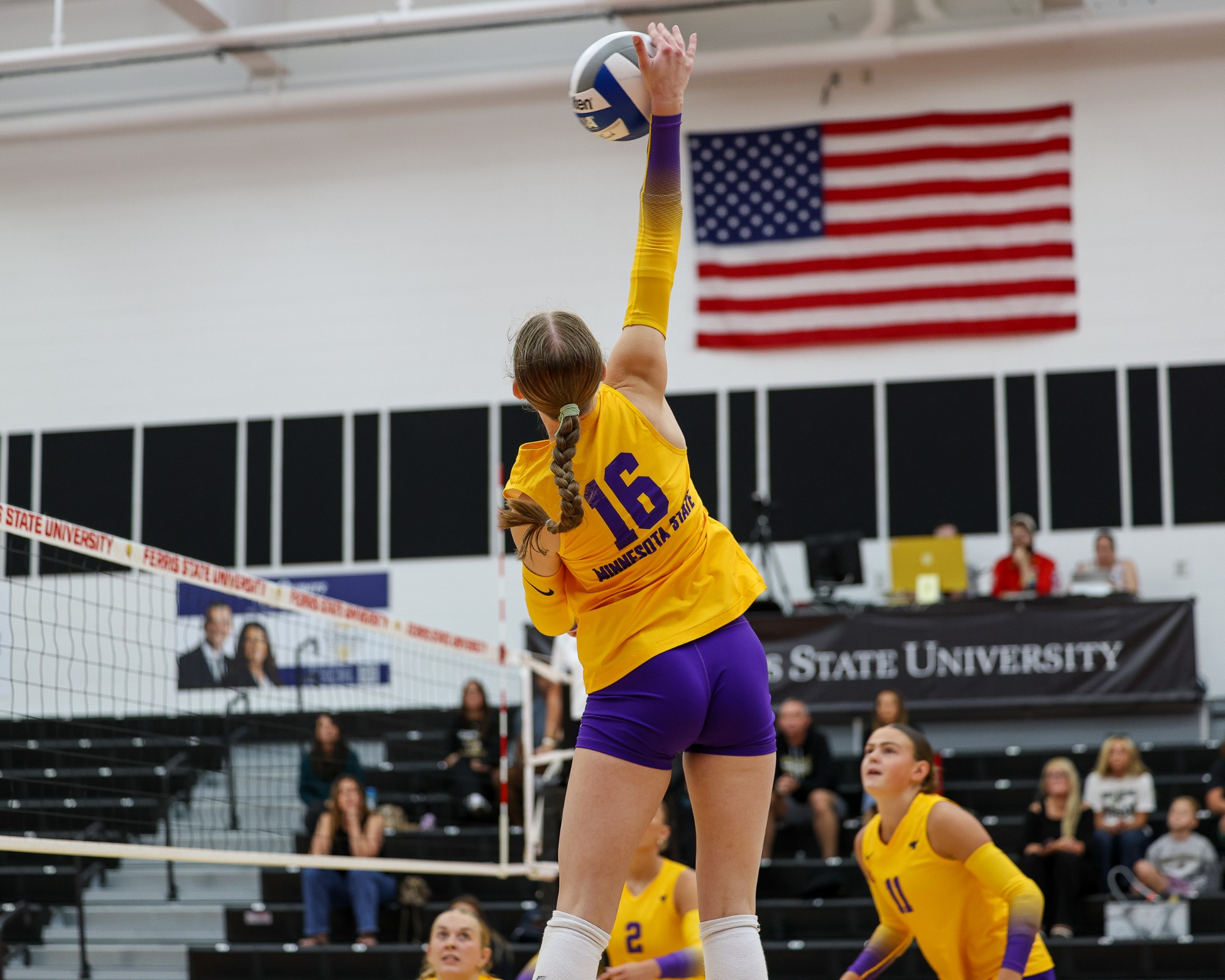 Lily Riese swinging at a volleyball