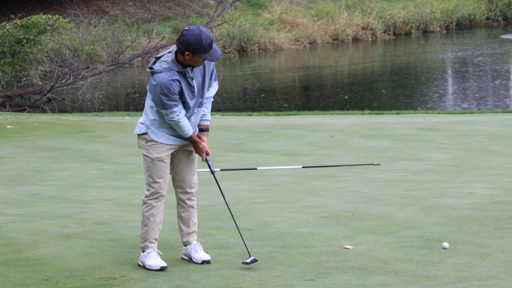 A photo of a Minnesota State Men's Golfer Putting on the green