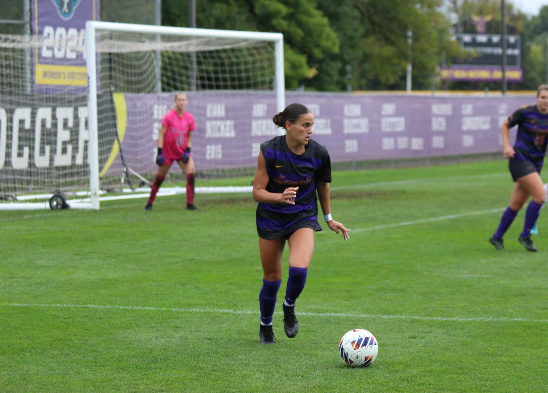 Mila Rustin dribbles the soccer ball