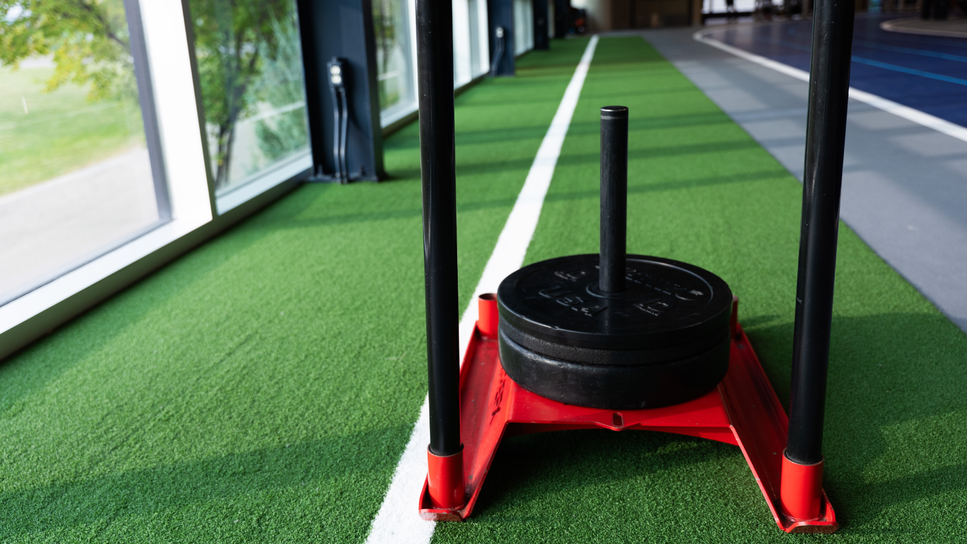 Sled with a 45lb and 25lb plate sits on top of the newly added turf 
