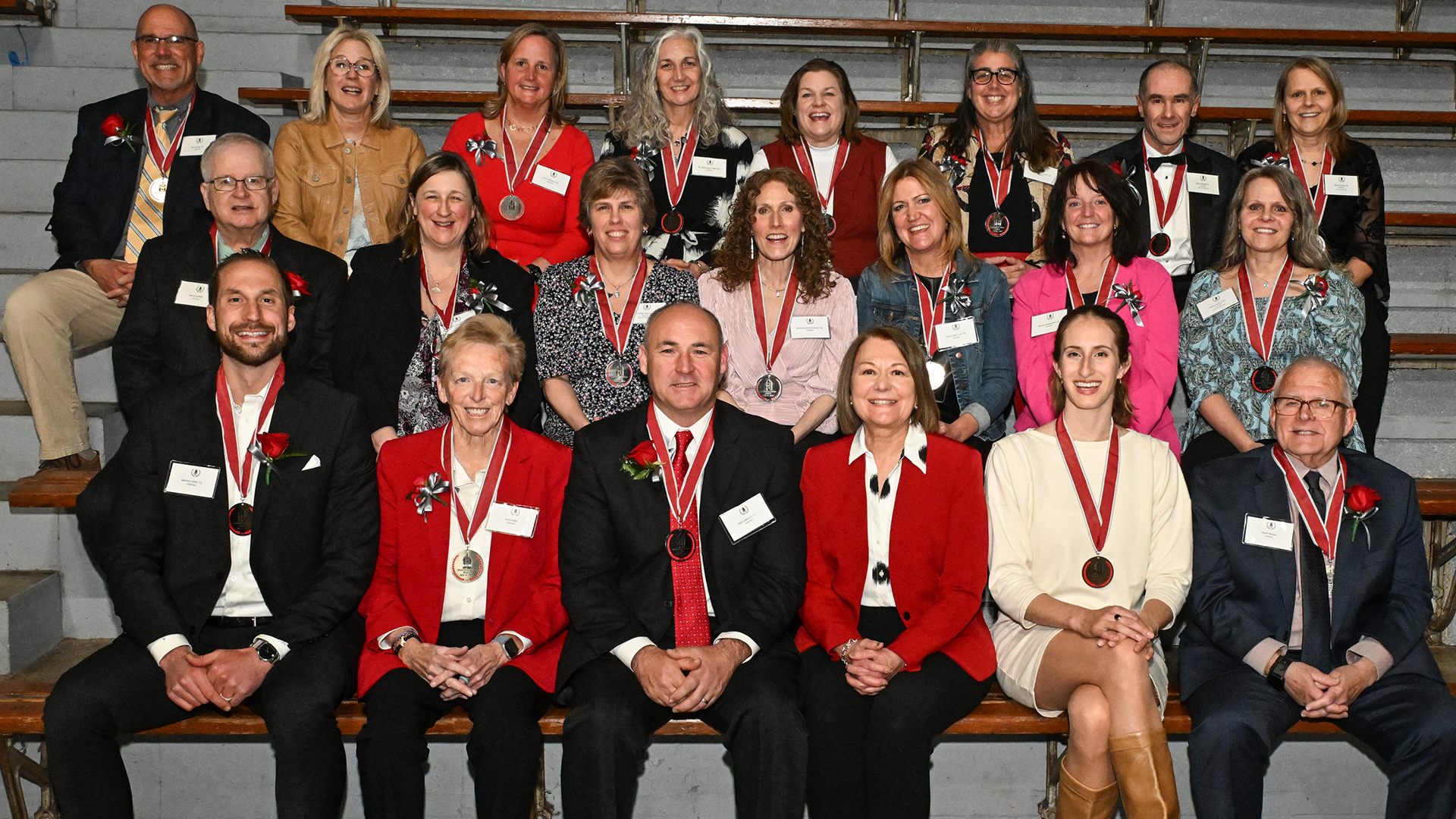 three rows of people wearing medals around their necks