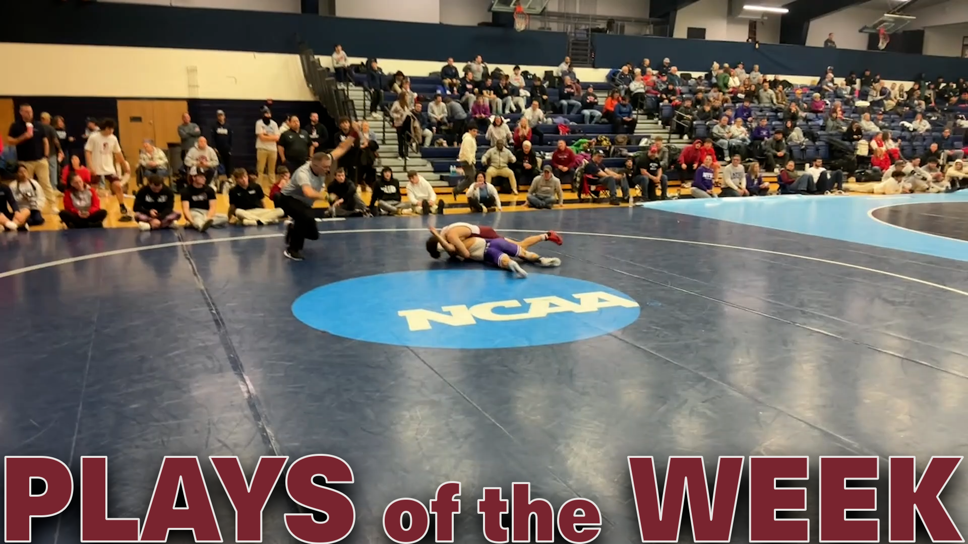 A pictures of two wrestlers on a mat with the light blue NCAA logo and the text Plays of the Week in red at the bottom