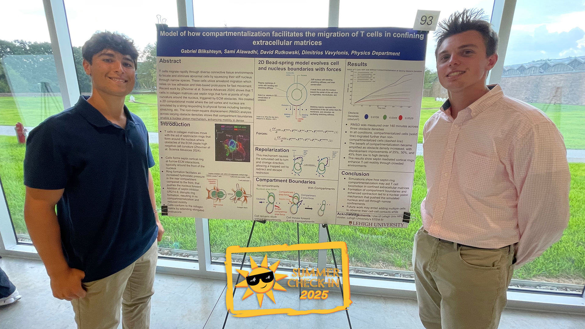 two young men stand on either side of a poster presentation on an easel