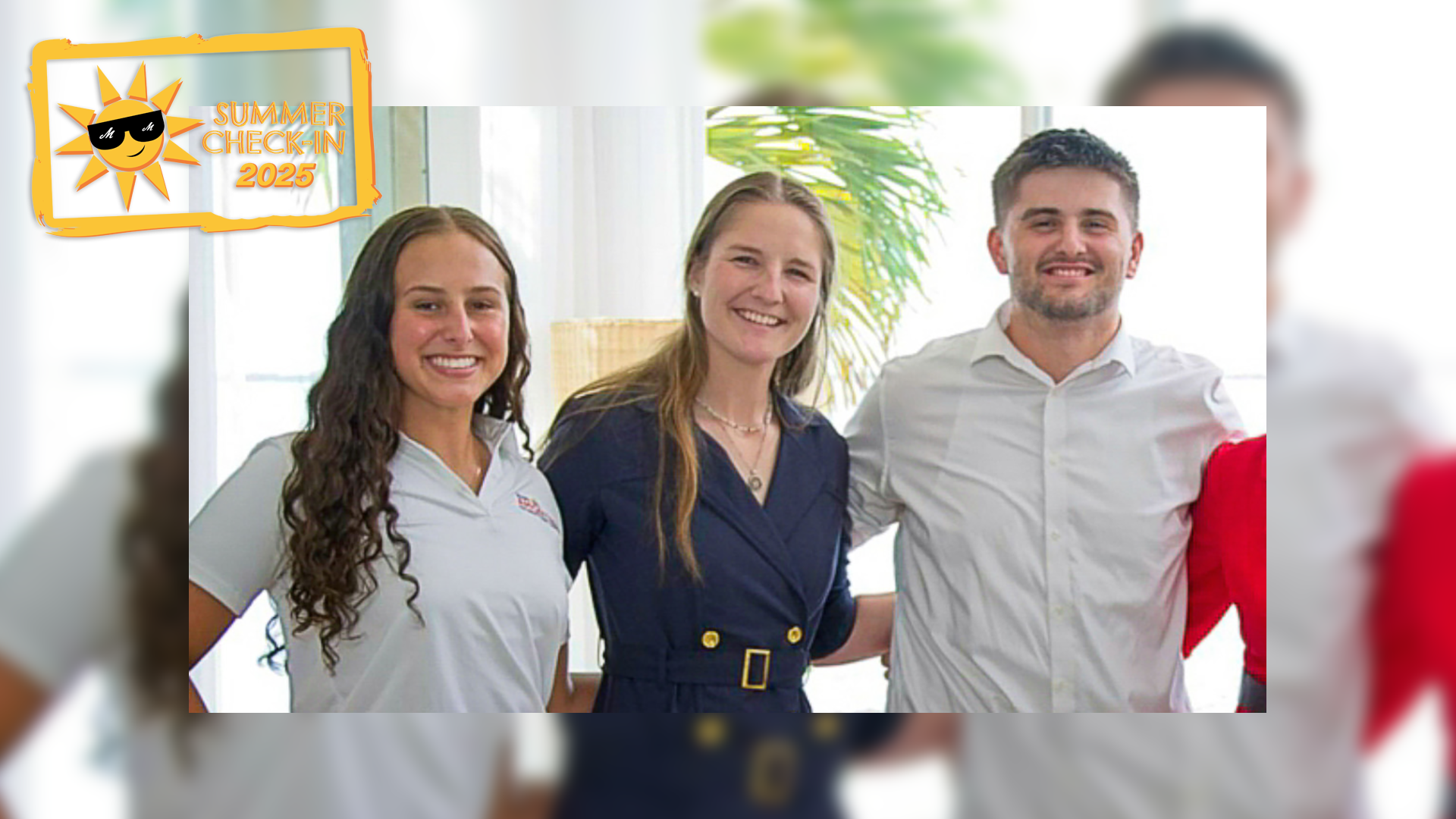 Two young women and a young man in dress clothes pose indoors