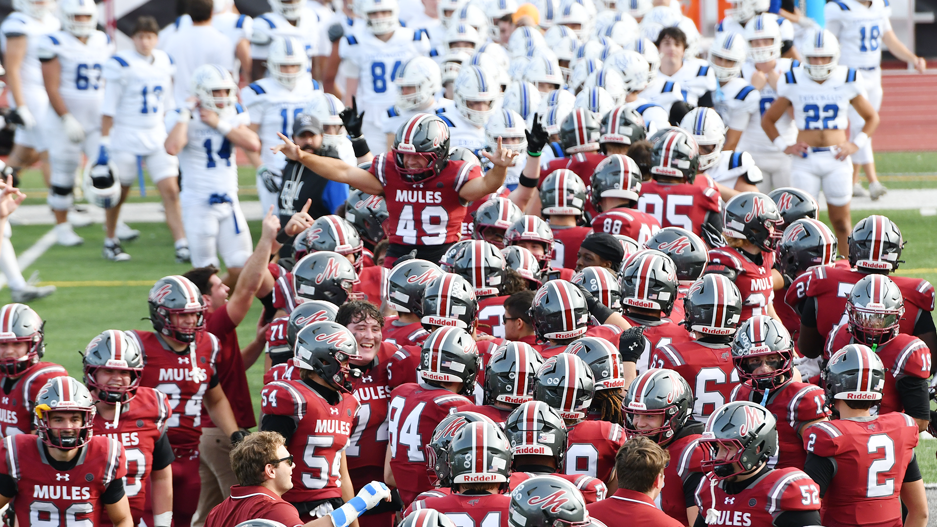 a football player in a red jersey and silver helmet being carried on the shoulders of his teammates