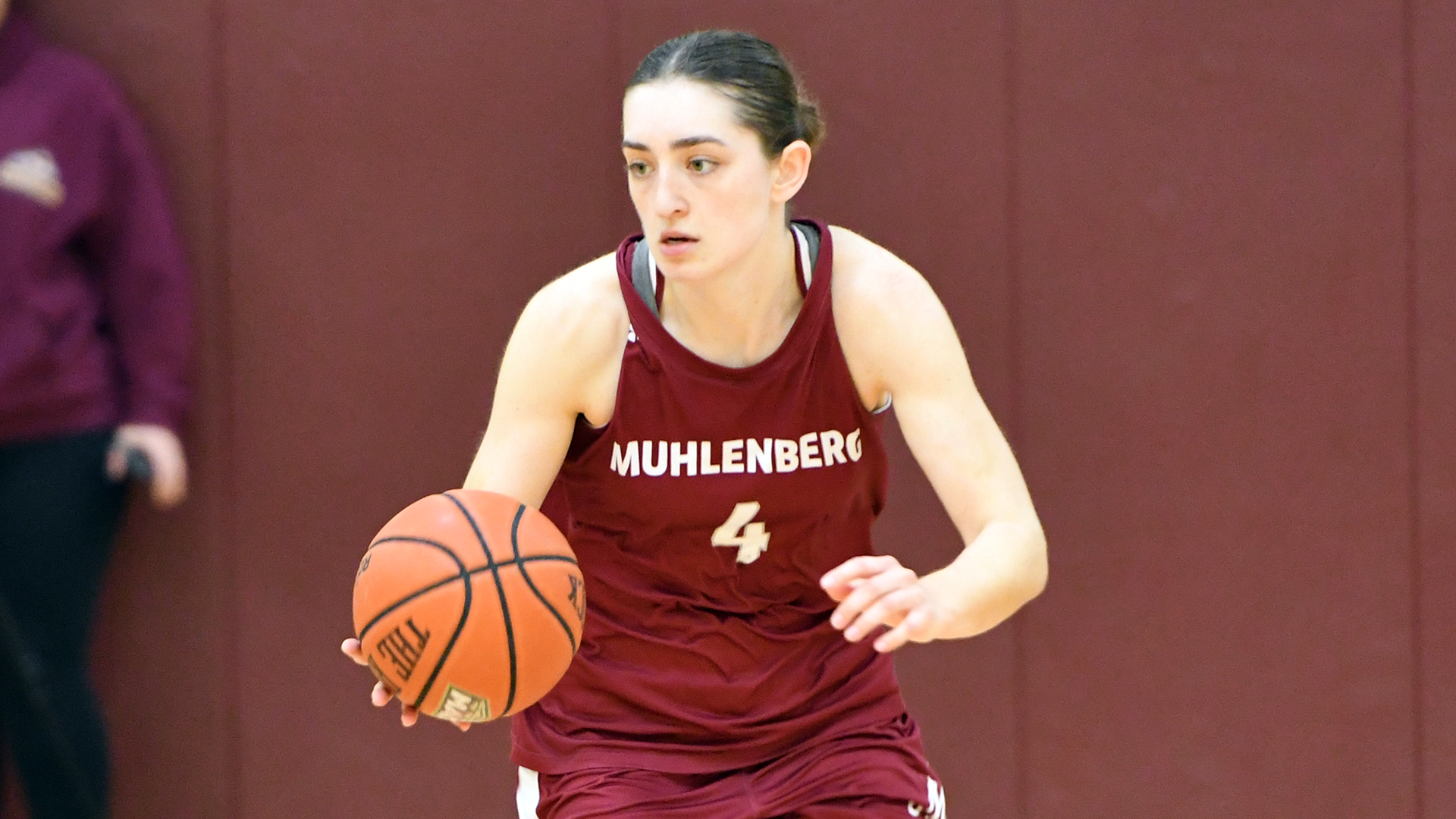 a basketball player wearing a red jersey with the number 4